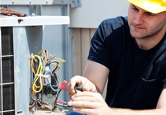 A man working on an electrical system.