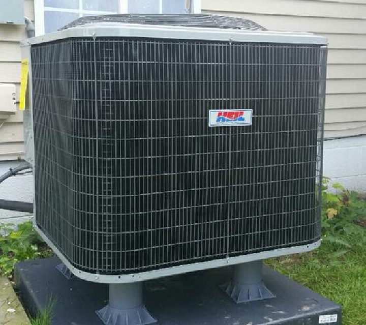 A black and white air conditioner sitting on top of a table.